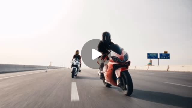 Two motorcycles riding a desert highway